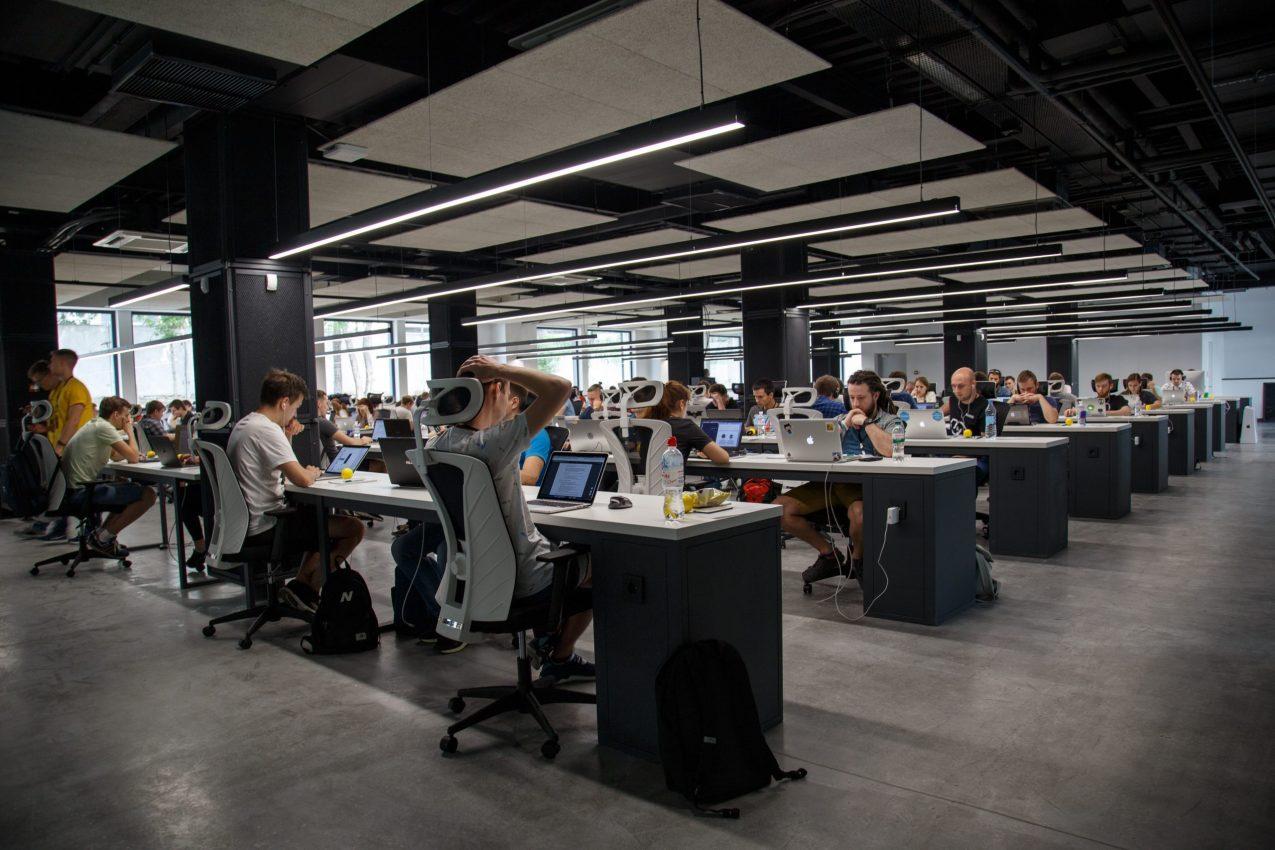 Employees working at desks in open plan office