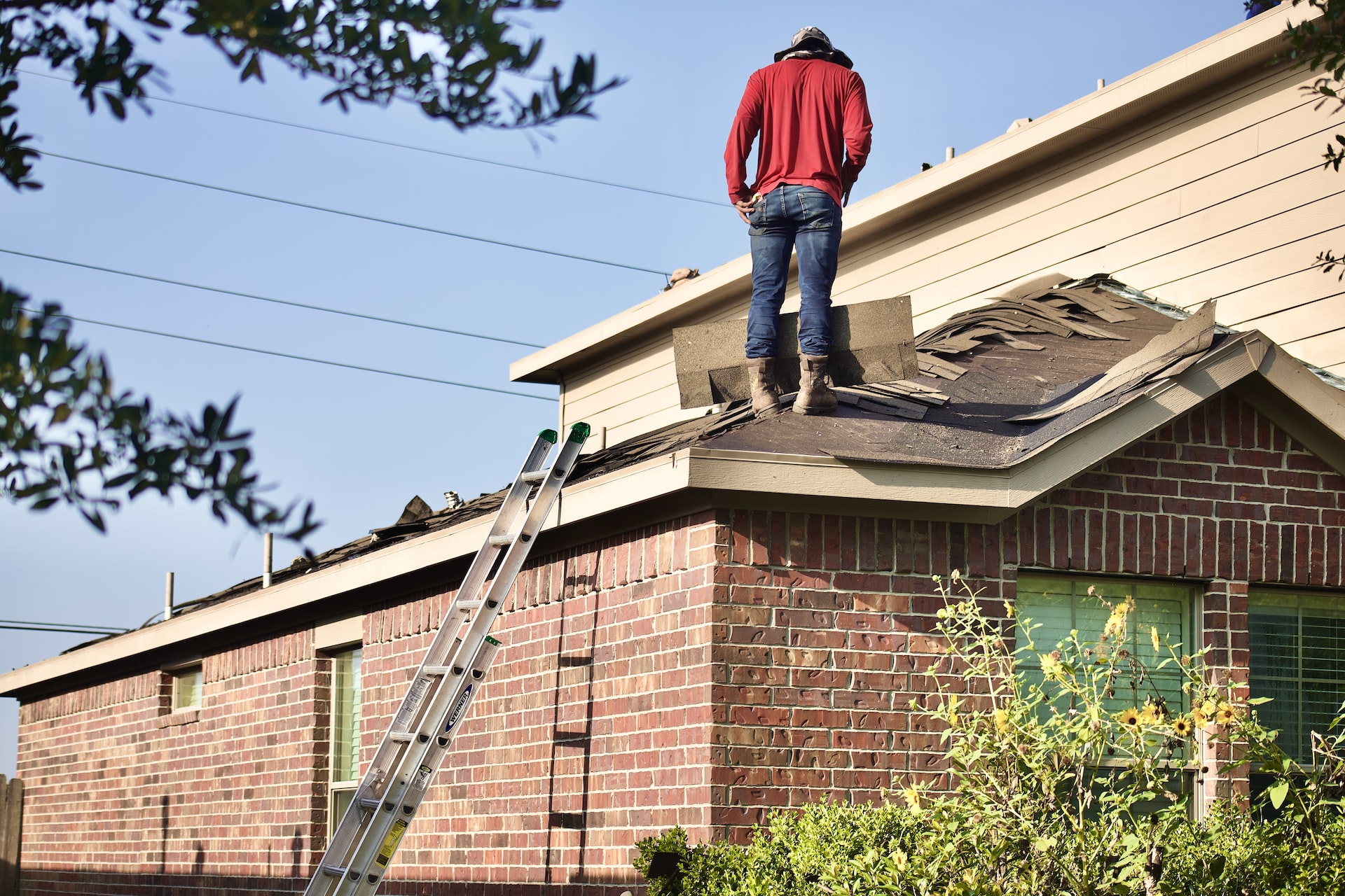 man replacing roof