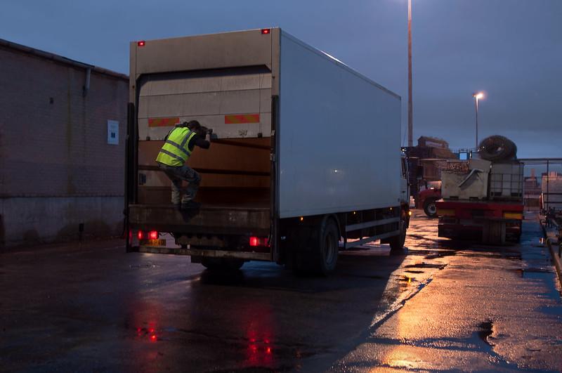 person opening the back of a lorry