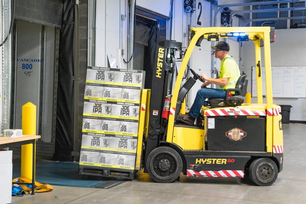 Forklift truck lifting goods in a warehouse